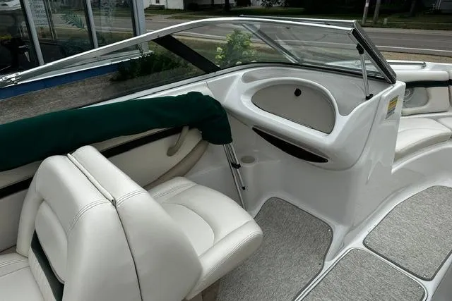 Slide: The Image of 1999 Chris-Craft 200 Bowrider SS interior with white seating and sleek dashboard design. - 15
