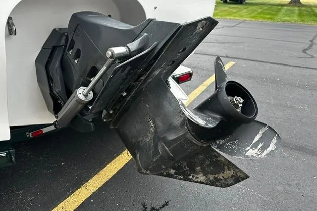 Slide: The Image of 1999 Chris-Craft 200 Bowrider SS boat propeller and outdrive on pavement. - 27
