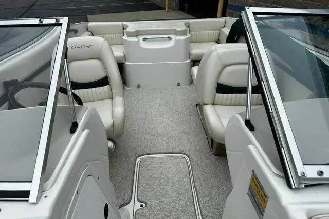 Slide: The Image of 1999 Chris-Craft 200 Bowrider SS interior with white seating and open cockpit design. - 24