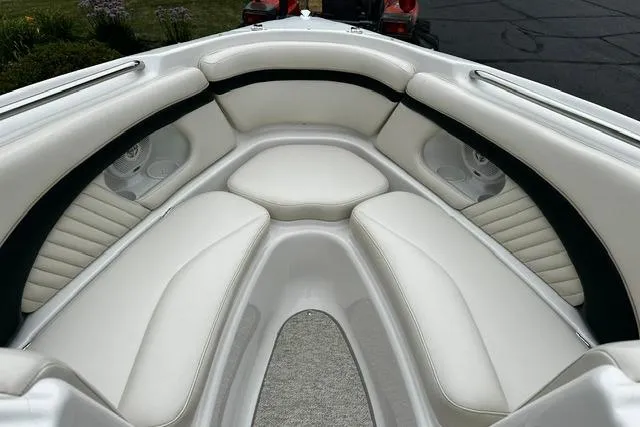 Slide: The Image of 1999 Chris-Craft 200 Bowrider SS interior with white cushioned seating. - 21
