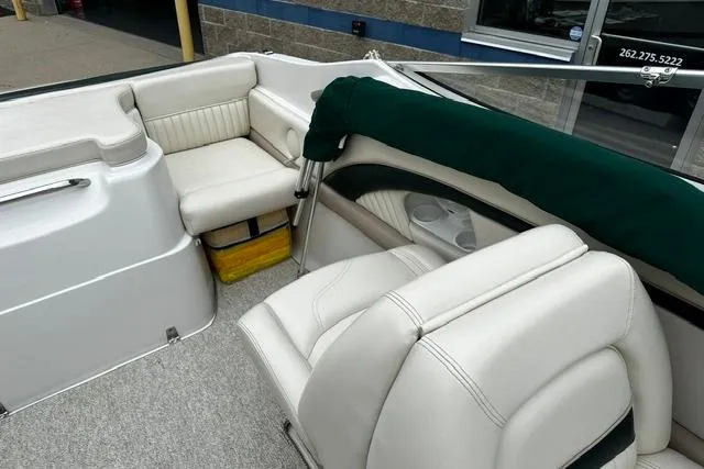 Slide: The Image of 1999 Chris-Craft 200 Bowrider SS interior with white seating and green cover. - 16