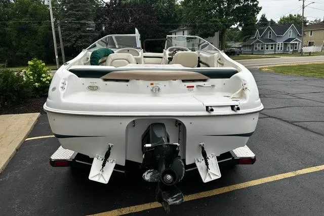 Slide: The Image of 1999 Chris-Craft 200 Bowrider SS boat, rear view, parked on asphalt. - 4