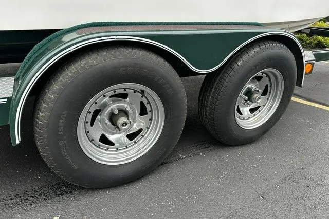 Slide: The Image of Trailer wheels of a 1999 Chris-Craft 200 Bowrider SS on asphalt pavement. - 36