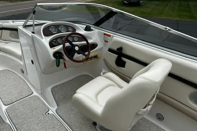 Slide: The Image of 1999 Chris-Craft 200 Bowrider SS interior with steering wheel and dashboard controls. - 10