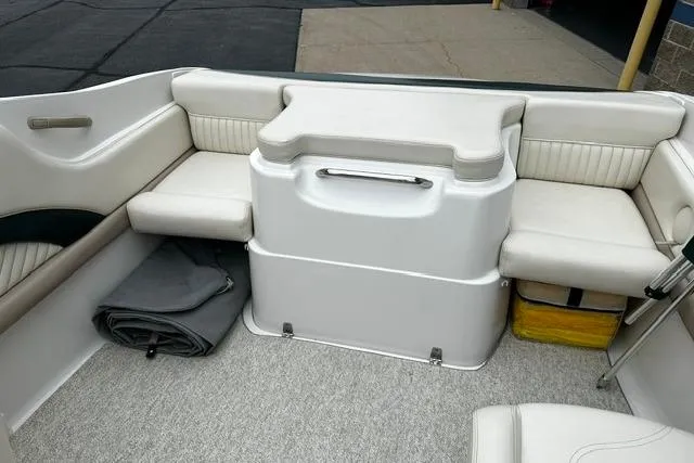 Slide: The Image of 1999 Chris-Craft 200 Bowrider SS interior with white seating and storage compartments. - 17