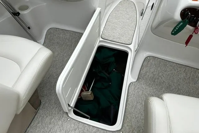 Slide: The Image of 1999 Chris-Craft 200 Bowrider SS interior storage compartment with open hatch and visible contents. - 18