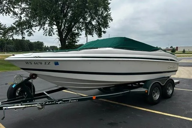 Slide: The Image of 1999 Chris-Craft 200 Bowrider SS on trailer, covered, parked outdoors. - 32