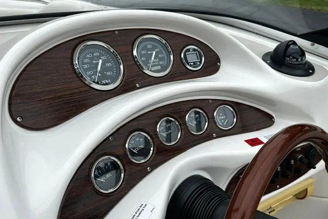 Slide: The Image of Dashboard of 1999 Chris-Craft 200 Bowrider SS with wood accents and gauges. - 13