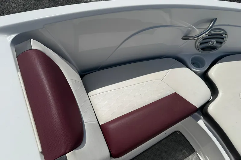 Slide: The Image of 2020 Tahoe 500 TS boat interior with maroon and white seating, cup holder, and speaker. - 21