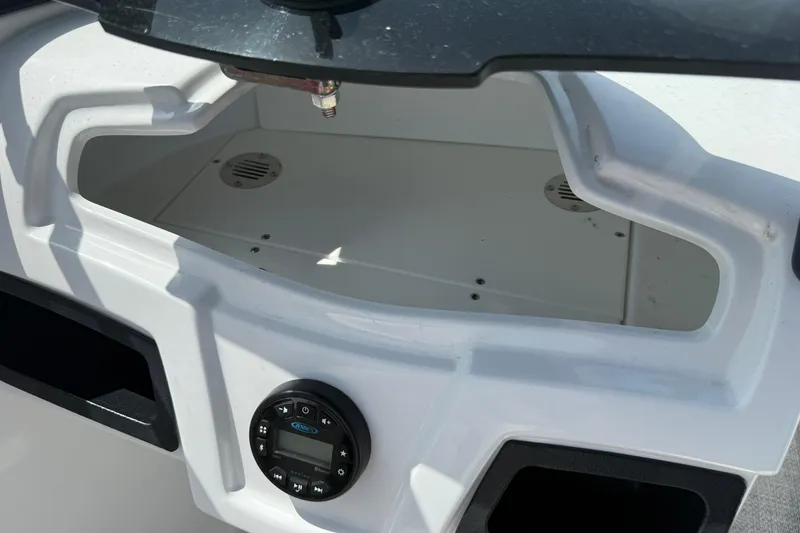 Slide: The Image of Dashboard of a 2020 Tahoe 500 TS boat with audio controls and storage compartment. - 25
