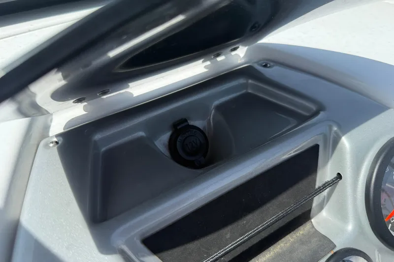 Slide: The Image of Dashboard compartment of 2020 Tahoe 500 TS boat with 12V power outlet. - 24