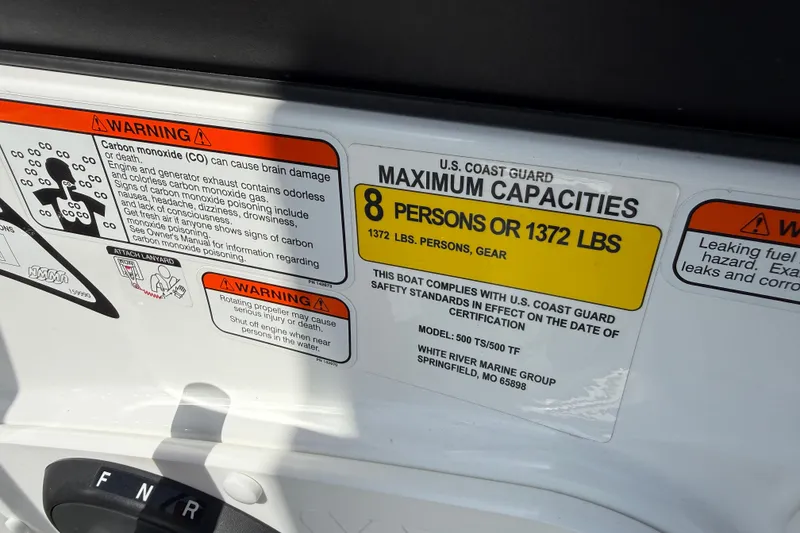 Slide: The Image of Warning labels on a 2020 Tahoe 500 TS boat, indicating maximum capacity and safety precautions. - 16
