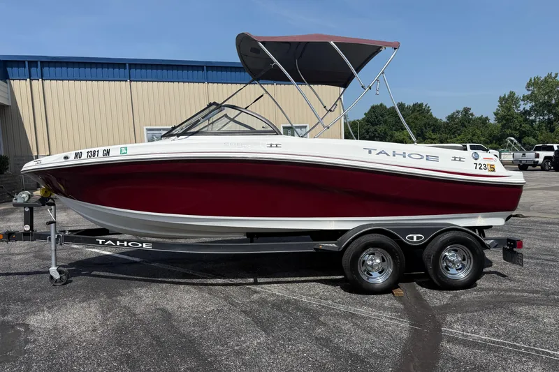 Slide: The Image of 2020 Tahoe 500 TS boat on trailer, red and white design, parked outdoors. - 2