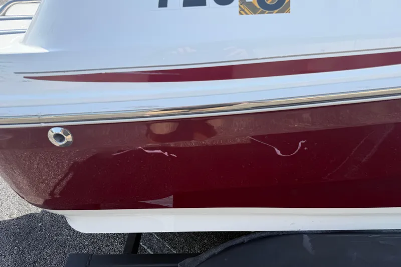 Slide: The Image of Red and white 2020 Tahoe 500 TS boat with visible scratches on the side. - 10