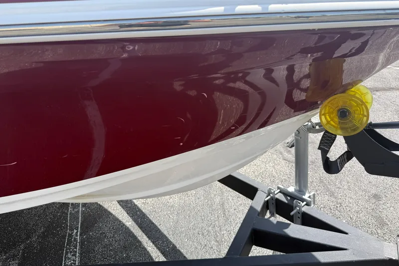 Slide: The Image of Red and white 2020 Tahoe 500 TS boat hull on trailer, close-up view. - 9