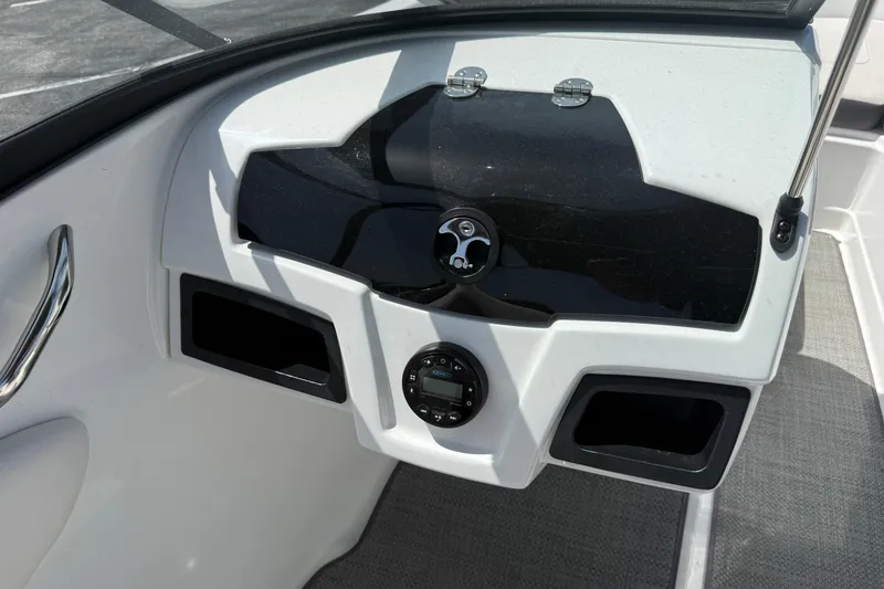 Slide: The Image of Dashboard of a 2020 Tahoe 500 TS boat with control panel and storage compartments. - 17