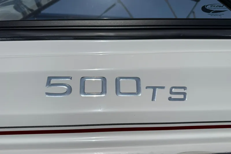 Slide: The Image of 2020 Tahoe 500 TS emblem on white surface with black trim. - 4