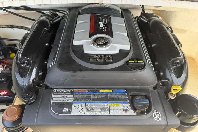 Slide: The Image of 2020 Tahoe 500 TS engine, featuring a Mercury 200 horsepower motor with maintenance schedule label. - 27