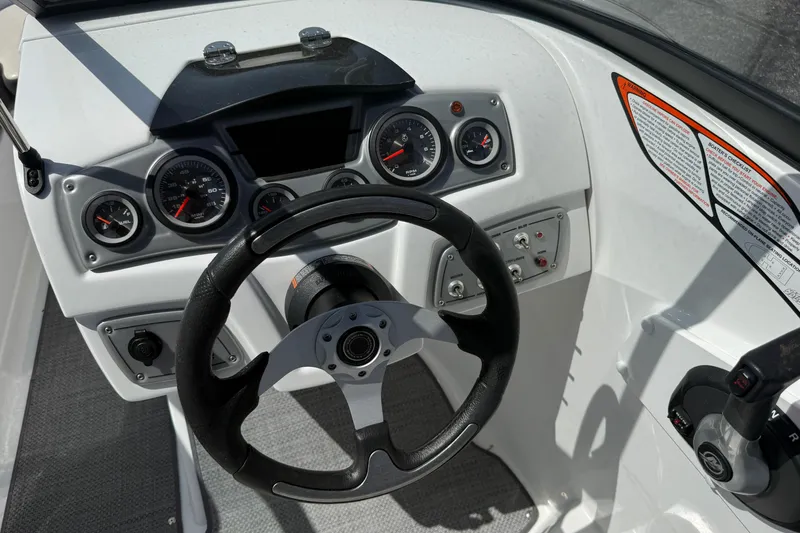 Slide: The Image of Steering console of 2020 Tahoe 500 TS boat with gauges and controls. - 15