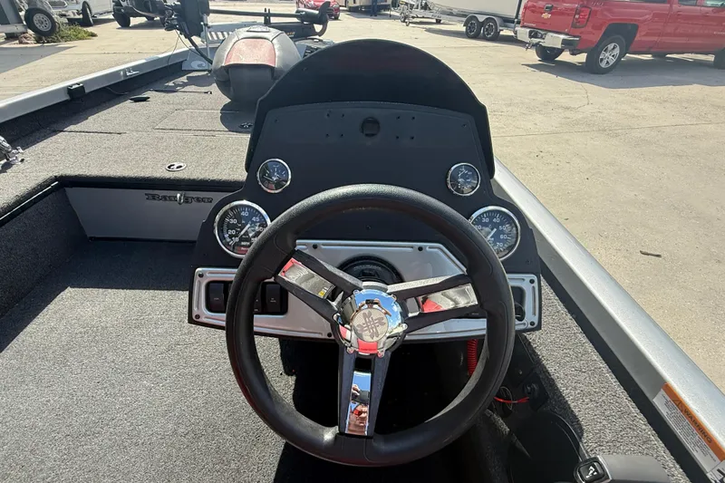 Slide: The Image of 2018 Ranger RT188C boat dashboard with steering wheel and gauges in a marina setting. - 12