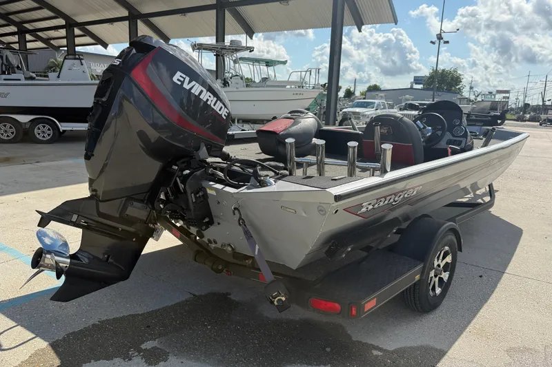 Slide: The Image of 2018 Ranger RT188C boat with Evinrude motor, parked under a canopy. - 6