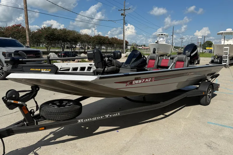 Slide: The Image of 2018 Ranger RT188C fishing boat on trailer, parked outdoors under blue sky. - 3