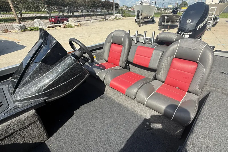 Slide: The Image of 2018 Ranger RT188C boat interior with red and gray seating, steering console, and Evinrude motor. - 11