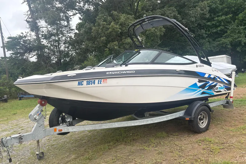 Slide: The Image of 2016 Yamaha Boats AR192 on trailer, parked outdoors with lush greenery background. - 3
