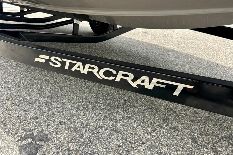 Slide: The Image of 2023 Starcraft SVX 211 IO boat trailer on pavement, showcasing brand logo. - 39