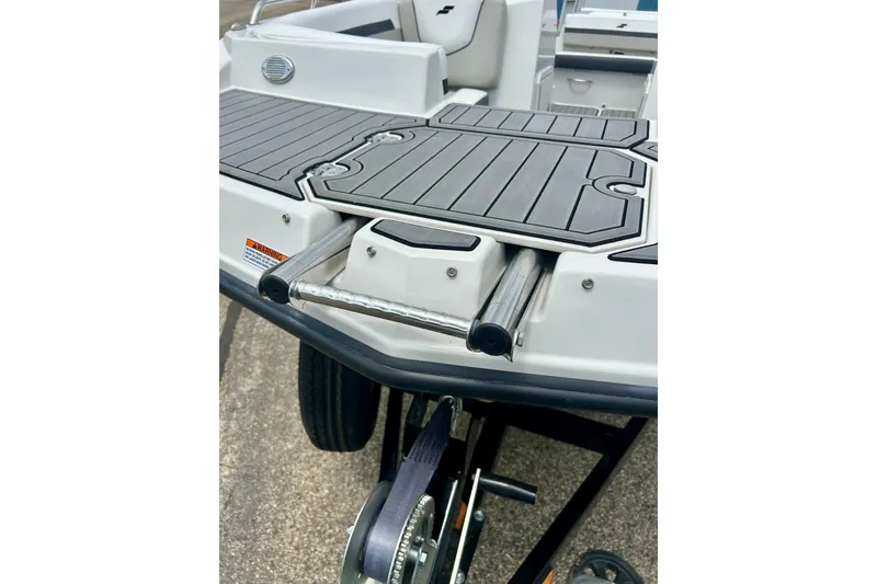 Slide: The Image of 2023 Starcraft SVX 211 IO boat with sleek deck design and retractable ladder. - 42