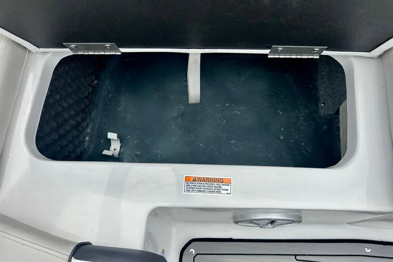 Slide: The Image of Storage compartment of 2023 Starcraft SVX 211 IO boat, featuring a warning label. - 20