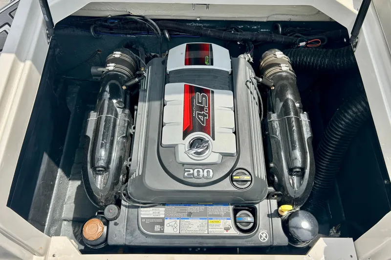 Slide: The Image of Engine compartment of 2023 Starcraft SVX 211 IO boat, featuring a 4.5L 200 horsepower engine. - 8