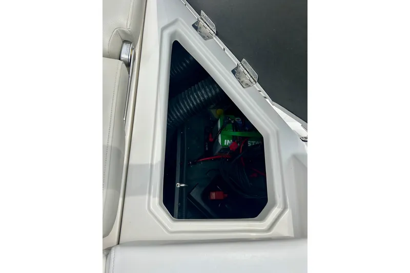 Slide: The Image of Storage compartment of 2023 Starcraft SVX 211 IO boat, featuring interior equipment and wiring. - 32