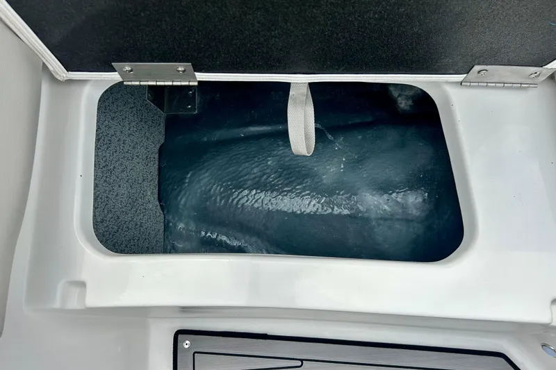 Slide: The Image of Storage compartment of 2023 Starcraft SVX 211 IO boat, featuring a hinged lid. - 23