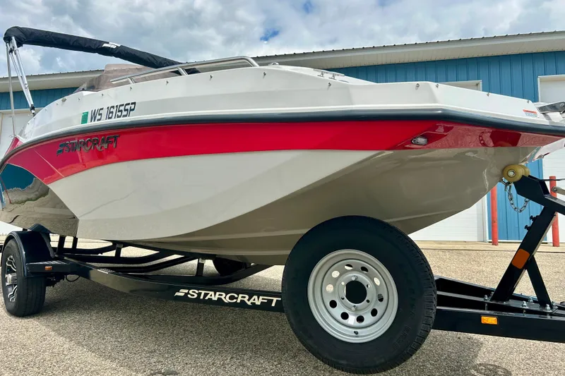 Slide: The Image of 2023 Starcraft SVX 211 IO boat on trailer, featuring red and white design. - 6