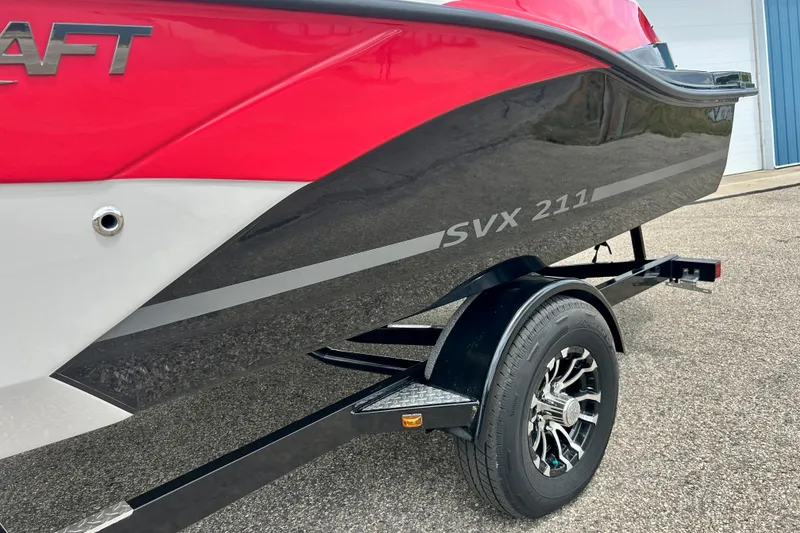 Slide: The Image of 2023 Starcraft SVX 211 IO boat on trailer, featuring sleek red and black design. - 7