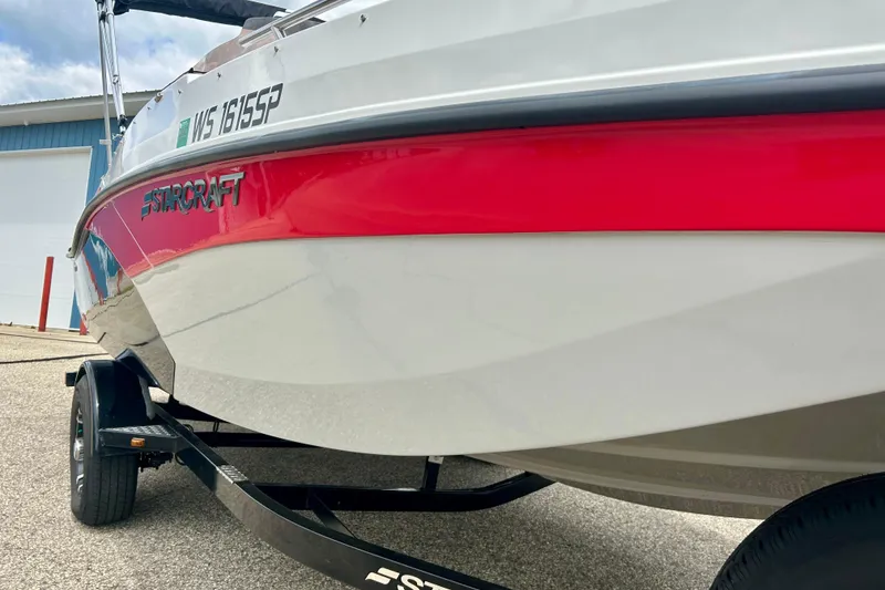 Slide: The Image of 2023 Starcraft SVX 211 IO boat with red and white hull on trailer. - 4