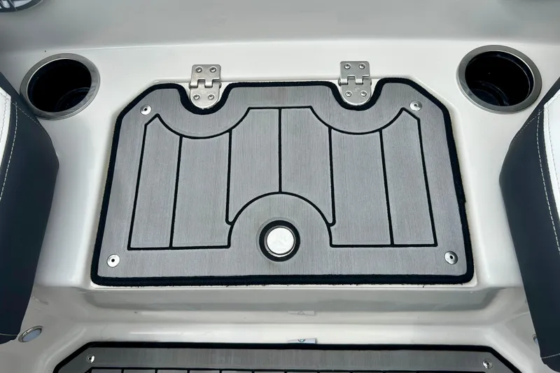 Slide: The Image of 2023 Starcraft SVX 211 IO boat interior with cup holders and storage compartment. - 29
