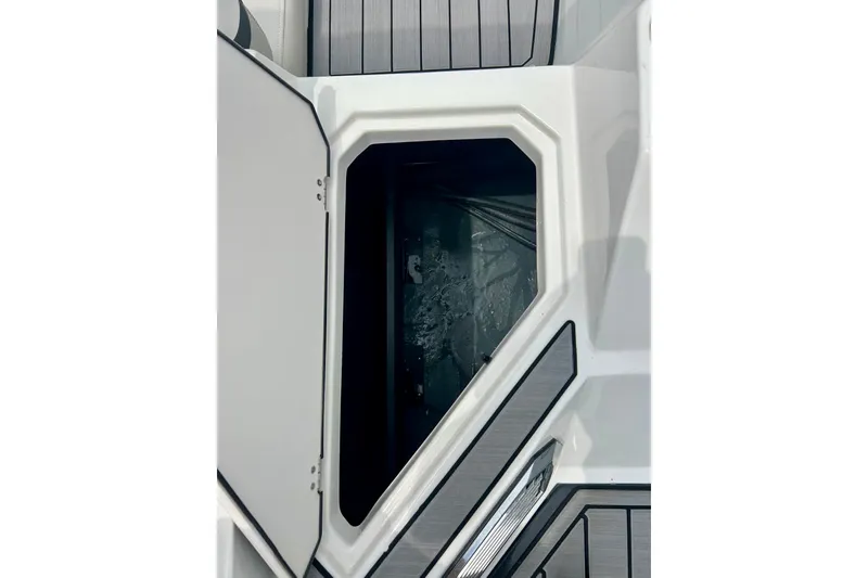 Slide: The Image of Open storage compartment on 2023 Starcraft SVX 211 IO boat, featuring sleek design and modern materials. - 61