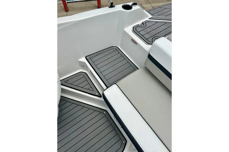 Slide: The Image of 2023 Starcraft SVX 211 IO boat interior with sleek gray decking and cushioned seating. - 18