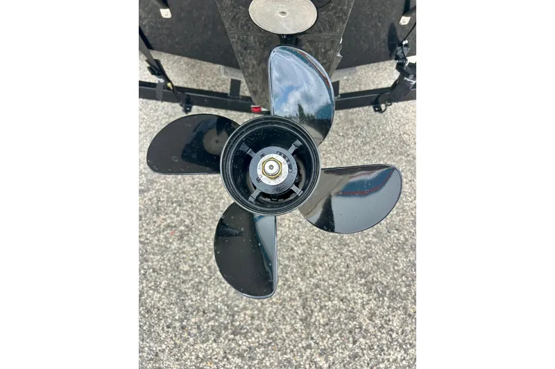 Slide: The Image of Close-up of a 2023 Starcraft SVX 211 IO boat propeller on pavement. - 10