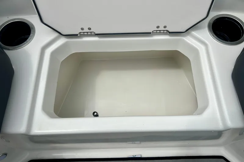 Slide: The Image of Open storage compartment on 2023 Starcraft SVX 211 IO boat with cup holders. - 26