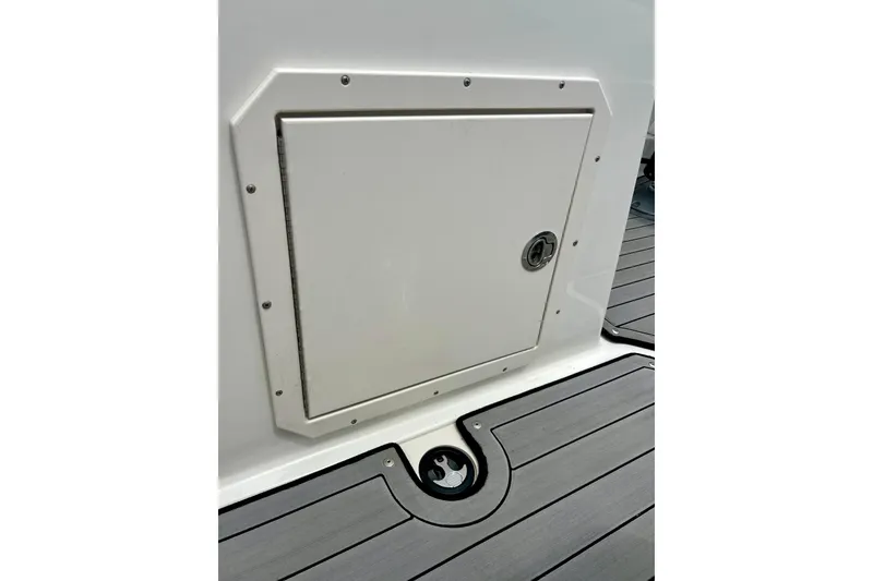 Slide: The Image of 2023 Starcraft SVX 211 IO boat storage compartment with sleek design and durable flooring. - 57