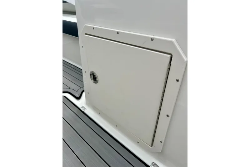 Slide: The Image of 2023 Starcraft SVX 211 IO boat storage compartment with sleek design and secure latch. - 50