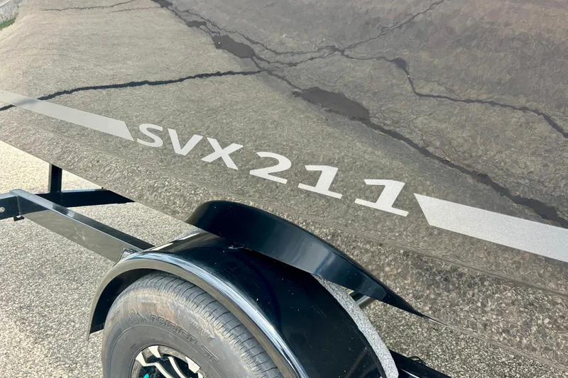 Slide: The Image of 2023 Starcraft SVX 211 IO boat on trailer, showcasing sleek design and branding. - 60