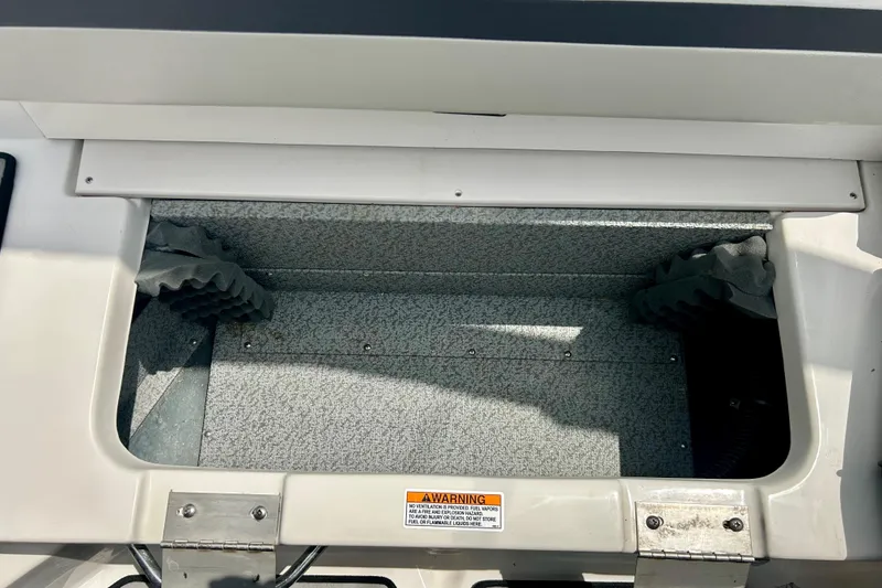 Slide: The Image of Storage compartment of 2023 Starcraft SVX 211 IO boat, featuring a textured interior. - 41