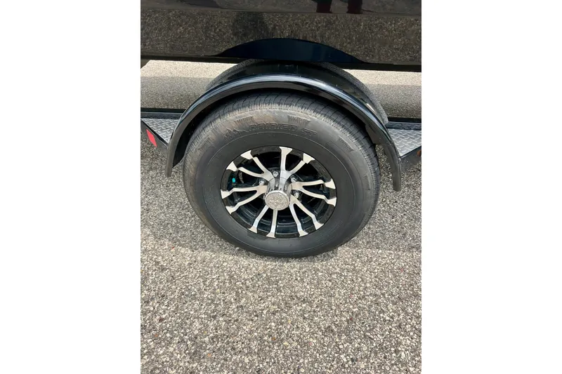 Slide: The Image of 2023 Starcraft SVX 211 IO trailer wheel on asphalt surface. - 36