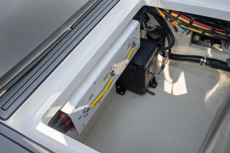 Slide: The Image of 2022 Fountain 38 SC boat electrical compartment with wiring and control panel. - 37