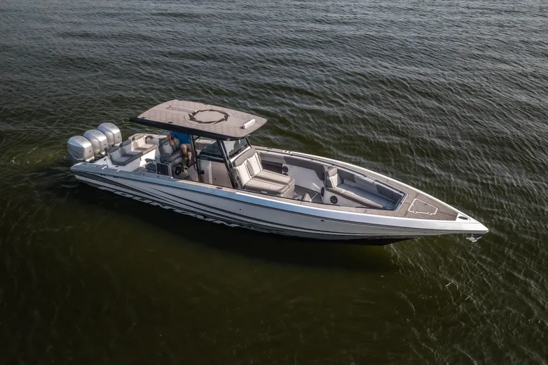 Slide: The Image of 2022 Fountain 38 SC boat cruising on open water, featuring triple outboard engines. - 4