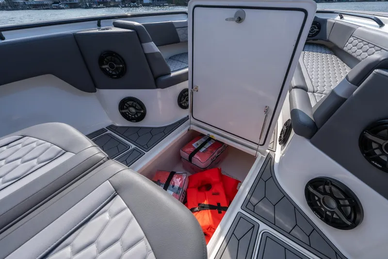 Slide: The Image of 2022 Fountain 38 SC boat interior with open storage compartment, life jackets, and speakers. - 43
